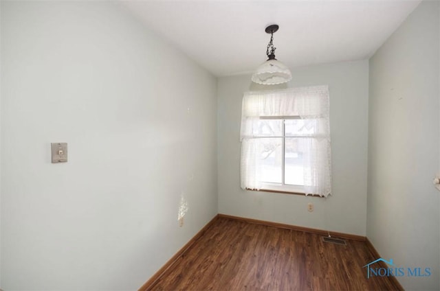 unfurnished room featuring dark hardwood / wood-style floors