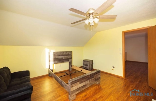 bedroom featuring hardwood / wood-style flooring, ceiling fan, and lofted ceiling