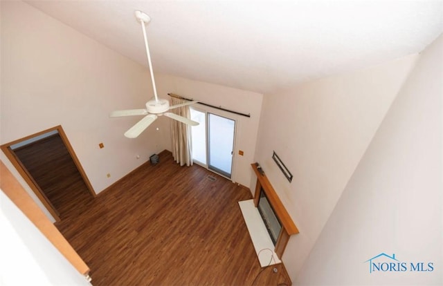 unfurnished living room with dark wood-type flooring