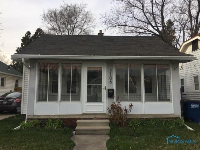 bungalow-style house with a sunroom