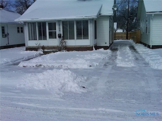 view of front of property with cooling unit and a sunroom