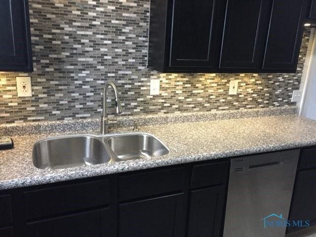 kitchen featuring tasteful backsplash, sink, stainless steel dishwasher, and light stone countertops