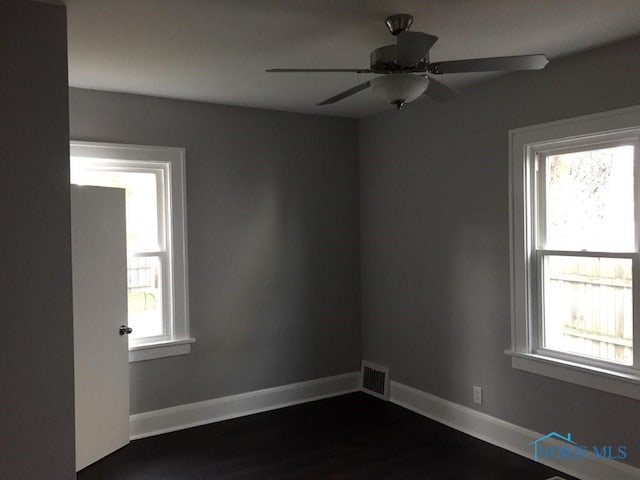 unfurnished room featuring a healthy amount of sunlight and ceiling fan