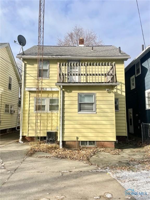 back of property with a balcony and central AC unit