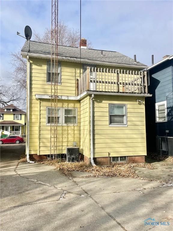 rear view of property with a balcony and central air condition unit