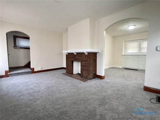 unfurnished living room featuring a brick fireplace and carpet floors