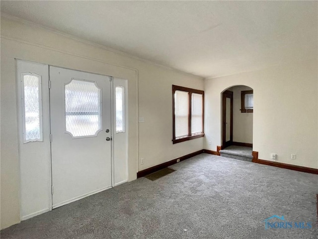 entryway featuring dark carpet