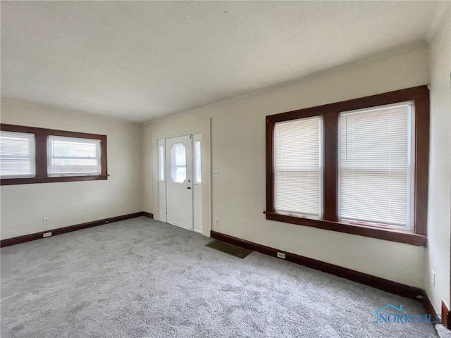 entrance foyer with light carpet