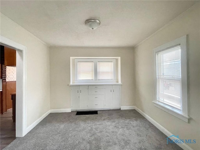 carpeted spare room with crown molding