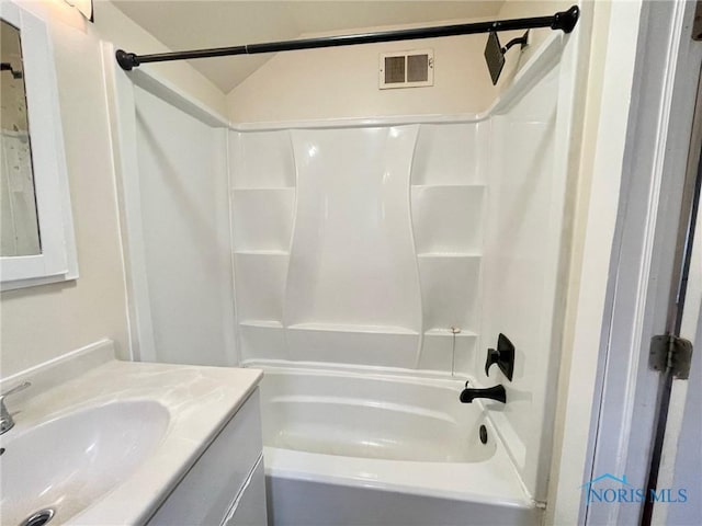 bathroom with vanity and washtub / shower combination