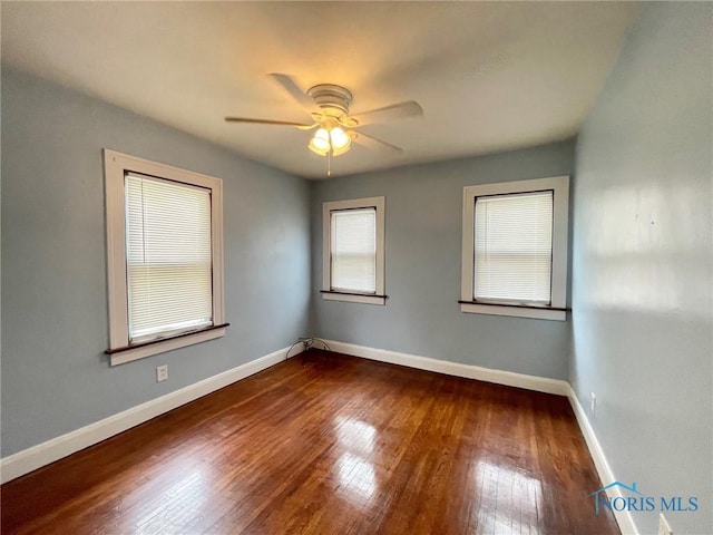 unfurnished room with ceiling fan and dark hardwood / wood-style floors