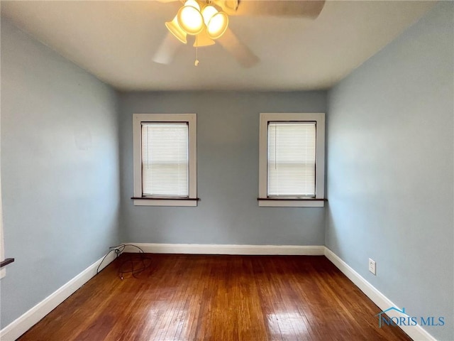 spare room featuring ceiling fan and dark hardwood / wood-style flooring