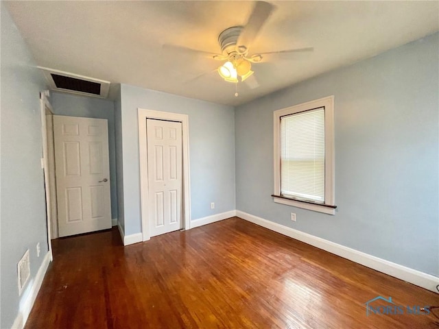 unfurnished bedroom with ceiling fan and dark hardwood / wood-style flooring