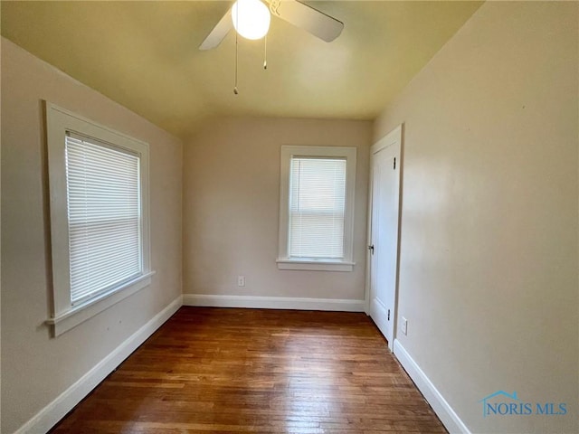 unfurnished room featuring ceiling fan and dark wood-type flooring