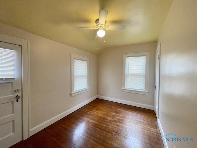 unfurnished room featuring ceiling fan, dark hardwood / wood-style floors, and lofted ceiling