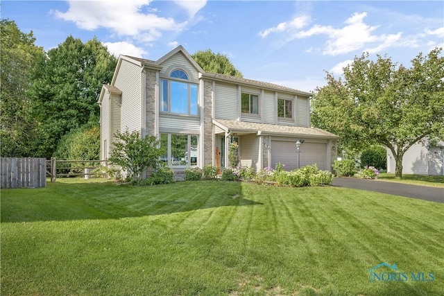 view of front of house featuring a garage and a front yard