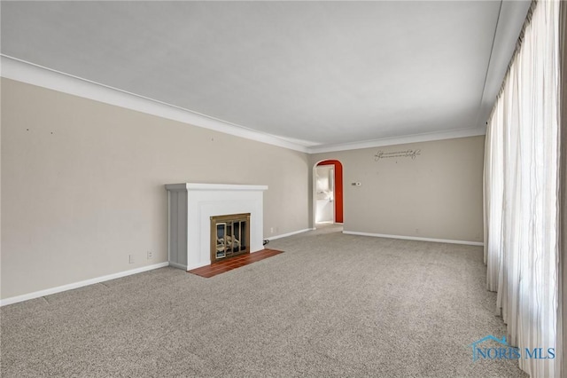 unfurnished living room featuring crown molding and carpet floors