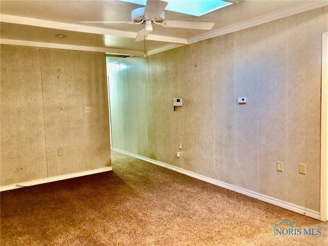 unfurnished room with a skylight, carpet flooring, and ceiling fan