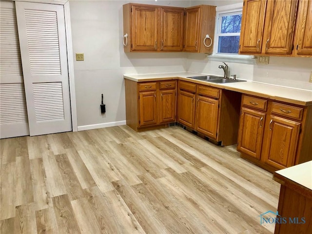 kitchen featuring sink and light wood-type flooring