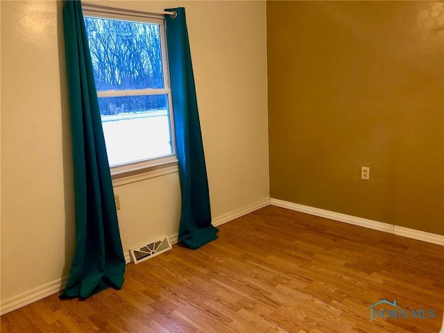 unfurnished room featuring hardwood / wood-style floors