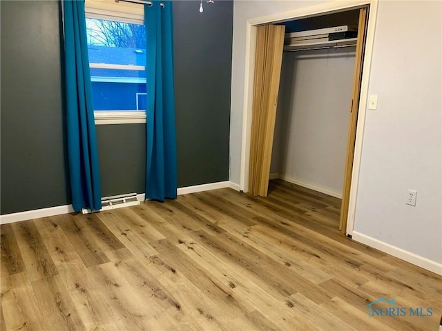 unfurnished bedroom featuring hardwood / wood-style flooring and a closet