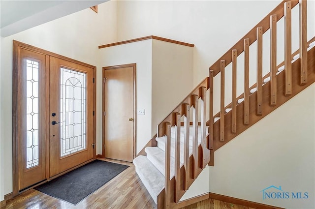 entryway with light hardwood / wood-style flooring and lofted ceiling