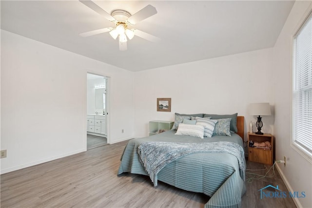 bedroom with ceiling fan, wood-type flooring, and ensuite bathroom