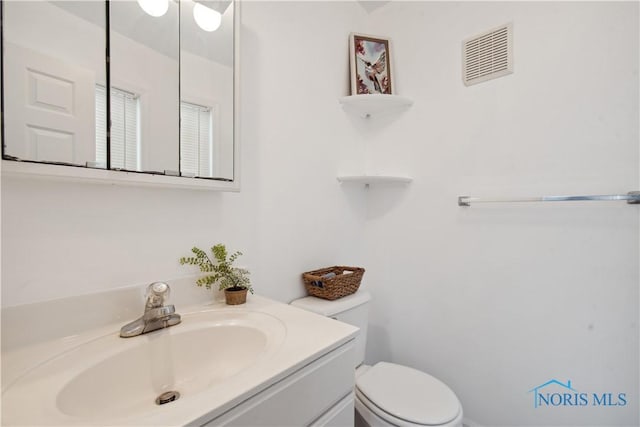 bathroom with toilet and vanity