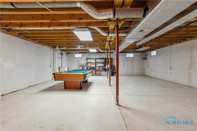 basement with brick wall and billiards