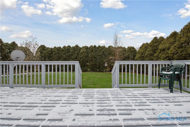 wooden terrace featuring a yard