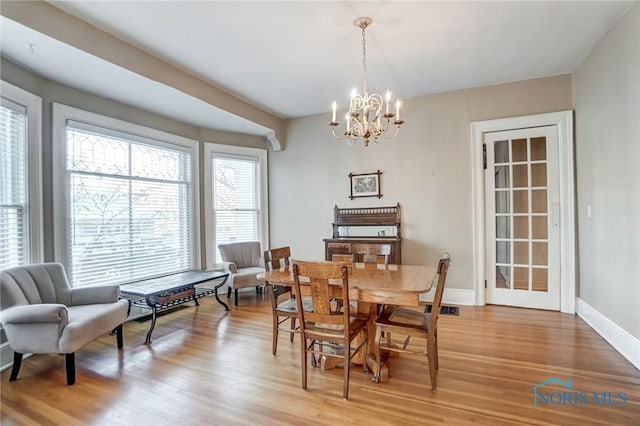 dining area featuring a chandelier and light hardwood / wood-style floors