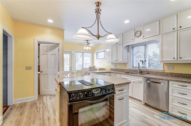 kitchen with stainless steel dishwasher, black electric range oven, and white cabinets