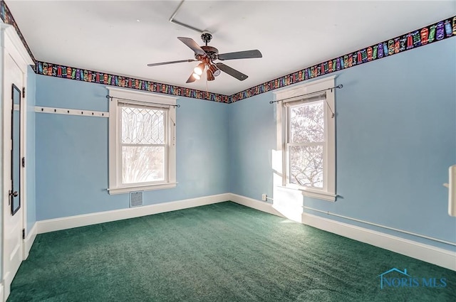 carpeted spare room with a healthy amount of sunlight and ceiling fan