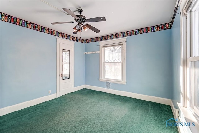 carpeted empty room featuring ceiling fan