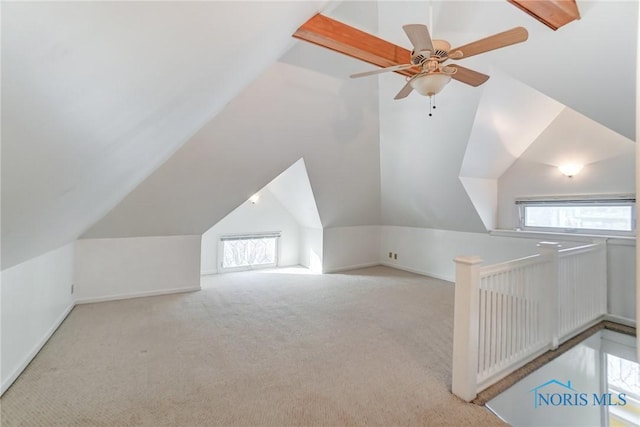 bonus room featuring a healthy amount of sunlight, light carpet, and lofted ceiling