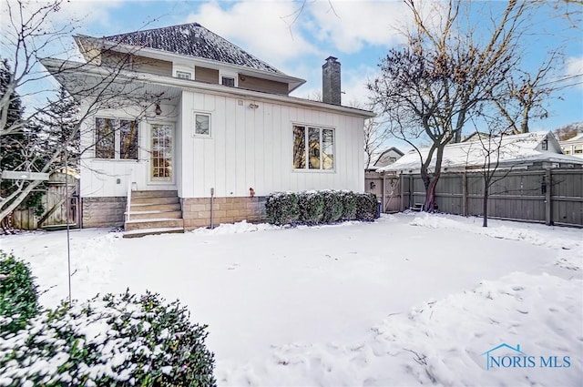 view of snow covered house