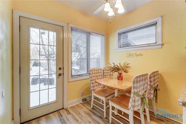 dining space with light hardwood / wood-style floors and ceiling fan