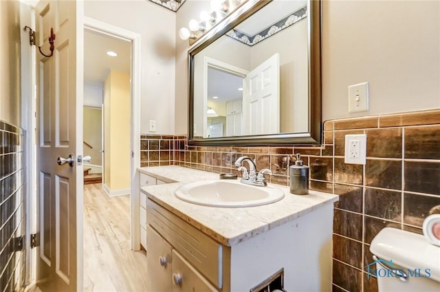 bathroom featuring vanity, toilet, and wood-type flooring