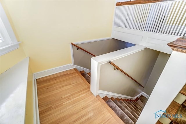 stairs with hardwood / wood-style floors