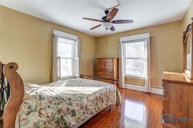 bedroom with ceiling fan and hardwood / wood-style floors