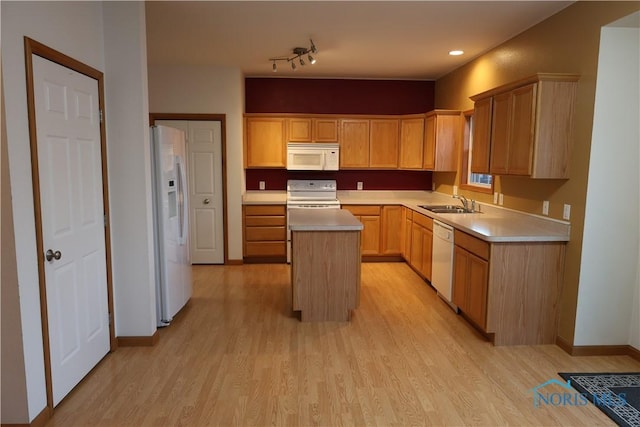 kitchen featuring a center island, light brown cabinets, white appliances, and light hardwood / wood-style flooring