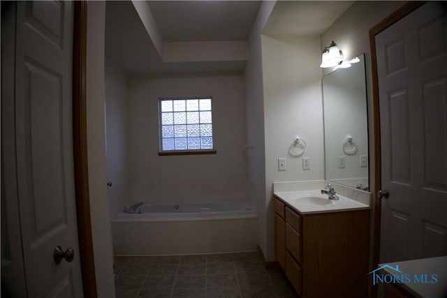 bathroom with vanity and a washtub