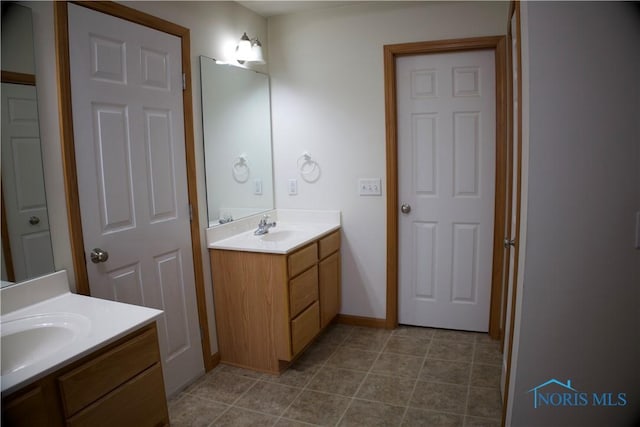 bathroom featuring tile patterned flooring and vanity