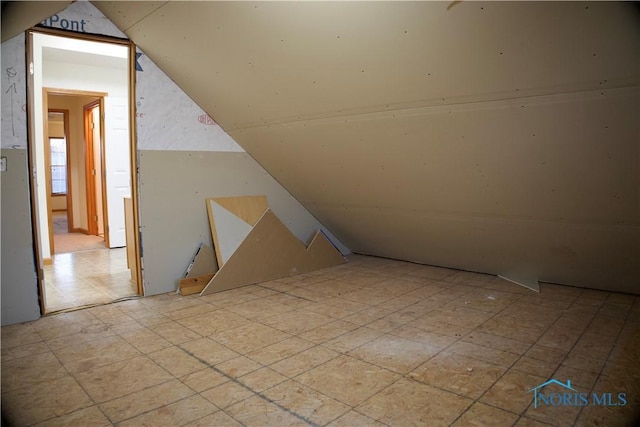 additional living space featuring lofted ceiling