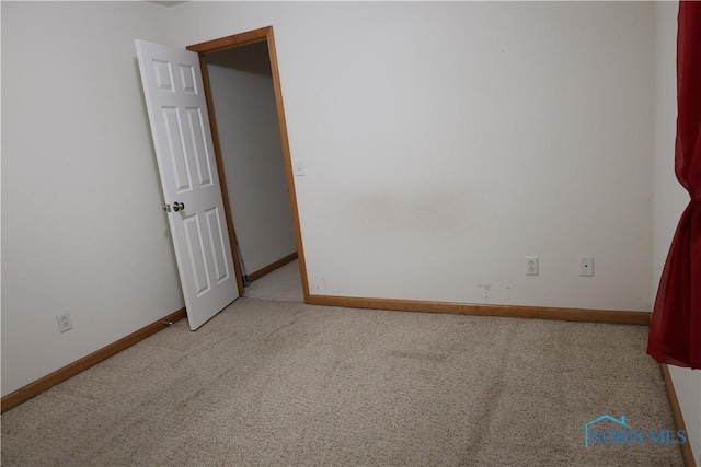 spare room with light carpet