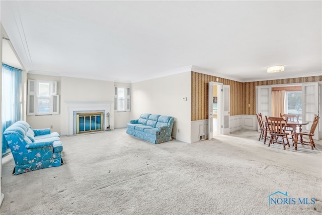 living room with ornamental molding and carpet flooring