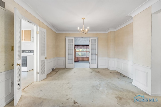 unfurnished room with french doors, ornamental molding, a chandelier, and washer / clothes dryer