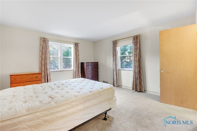 bedroom featuring light colored carpet