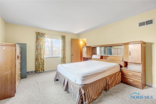 bedroom with light colored carpet