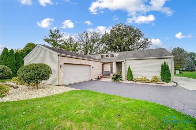 view of front of house featuring a garage and a front lawn